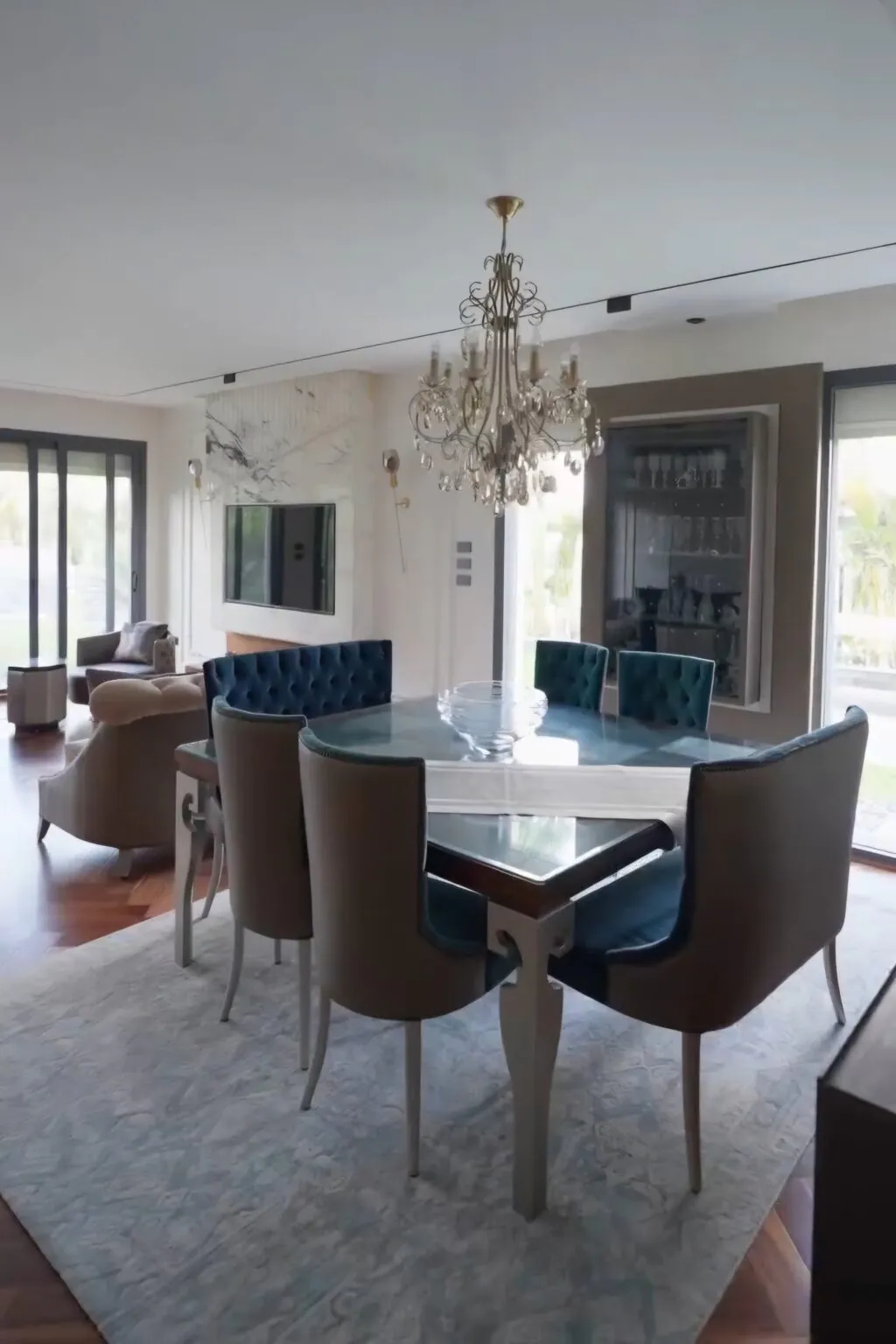 Chic dining area with a large wooden dining table, modern chairs, and elegant pendant lighting in New Cairo.