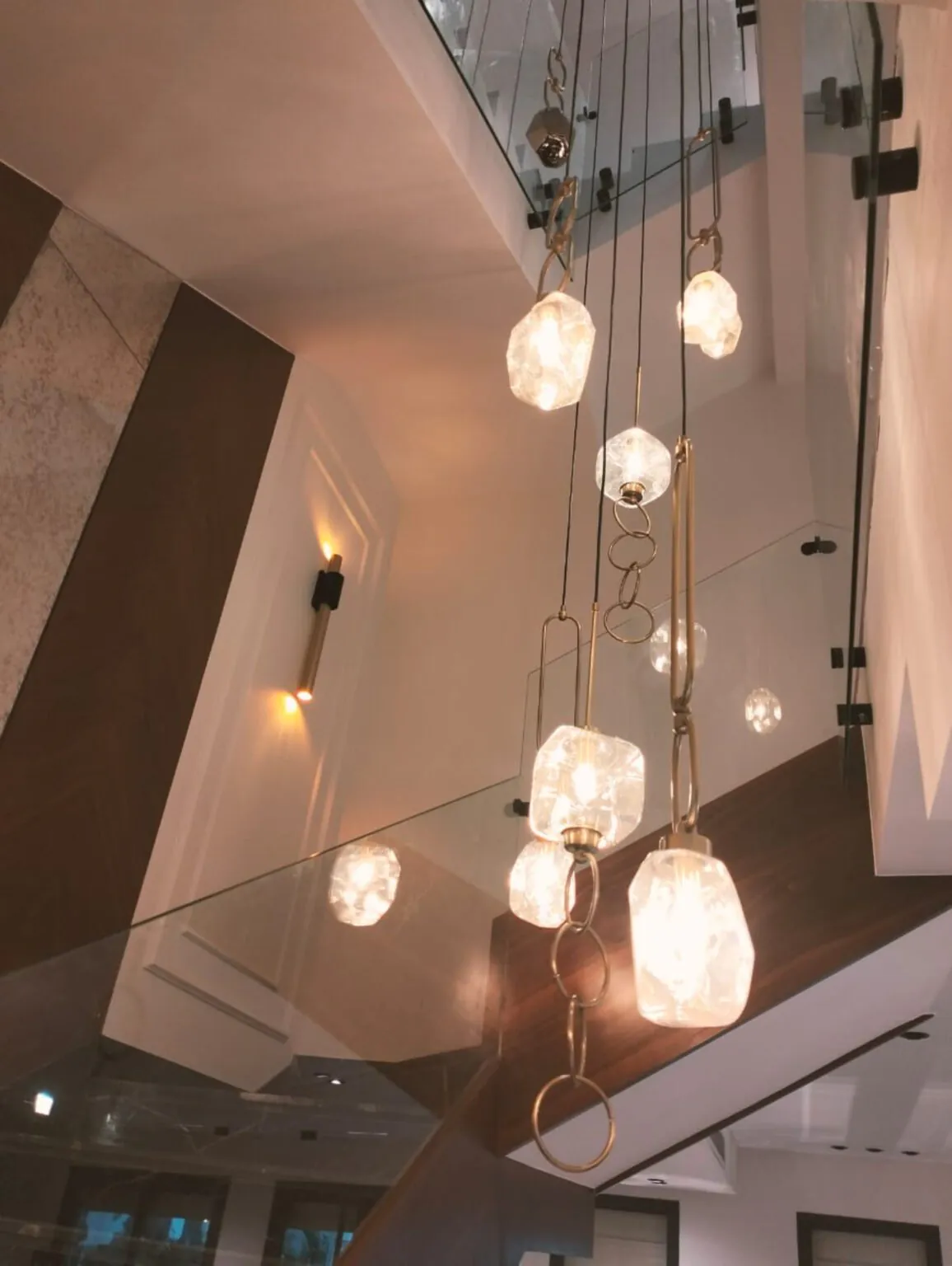 Stylish entryway with a decorative chandelier, wall-mounted mirror, and custom woodwork from Consept Art's site work portfolio.
