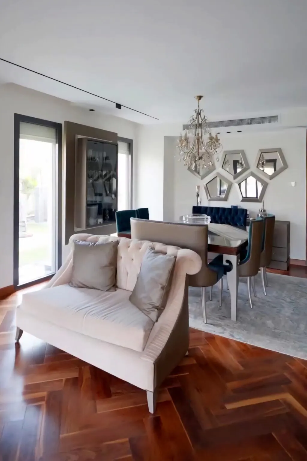 Modern living room with a beige sectional sofa, a glass coffee table, and large floor-to-ceiling windows complemented by beige curtains from Consept Art's site work portfolio.