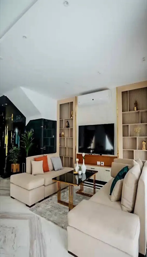 Contemporary living room featuring a sleek sectional sofa, a flat-screen TV, and ambient lighting in New Cairo from Consept Art's site work portfolio.