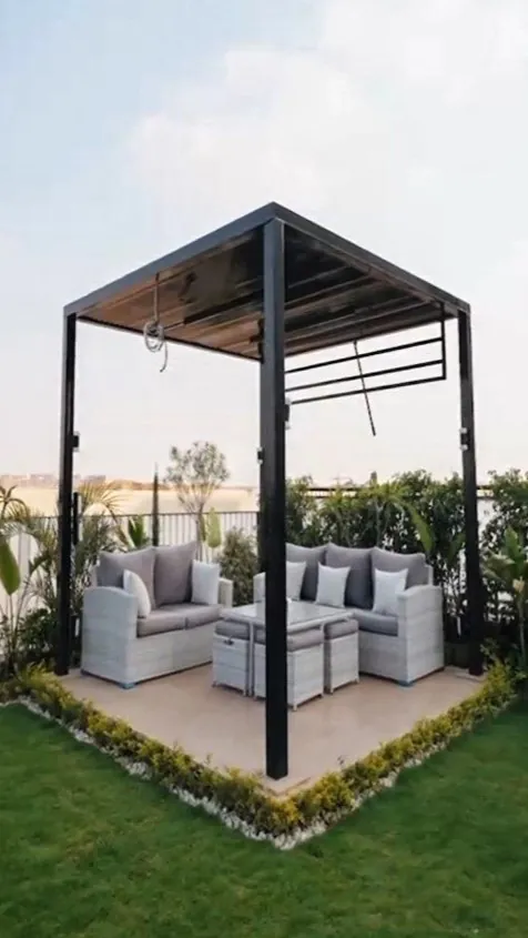 Outdoor seating area featuring a shaded pergola, white furniture, and lush garden surroundings from Consept Art's site work portfolio.