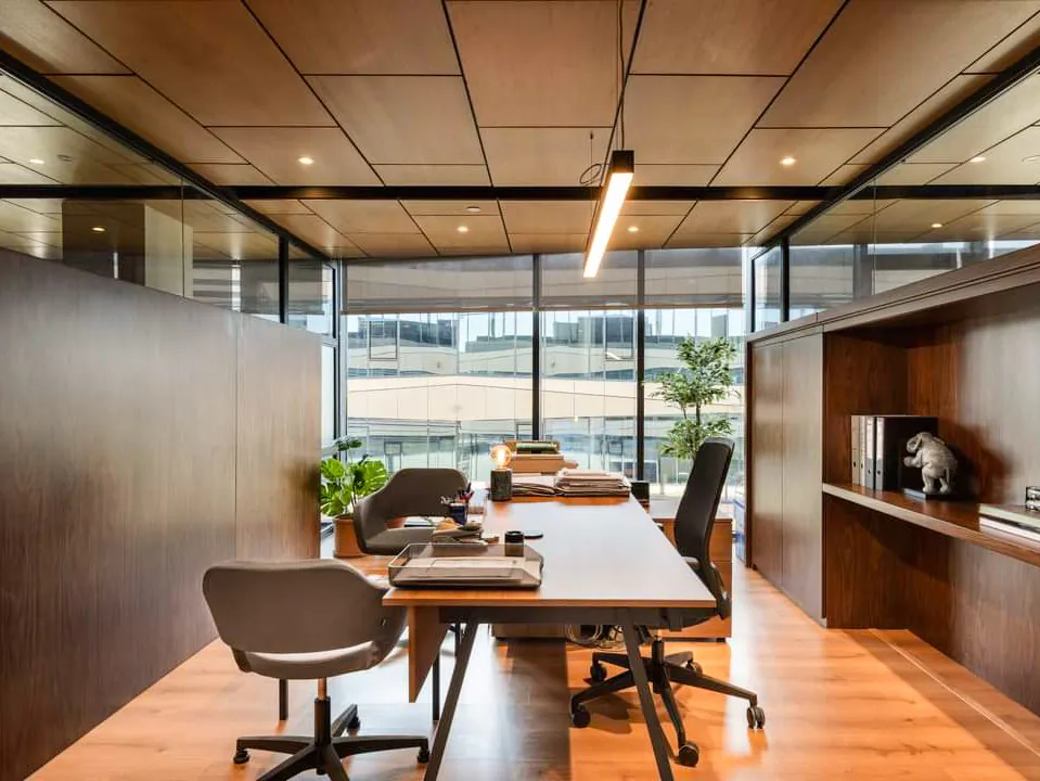 Industrial-style workspace featuring exposed brick, concrete floors, and minimal decor for a contemporary look.