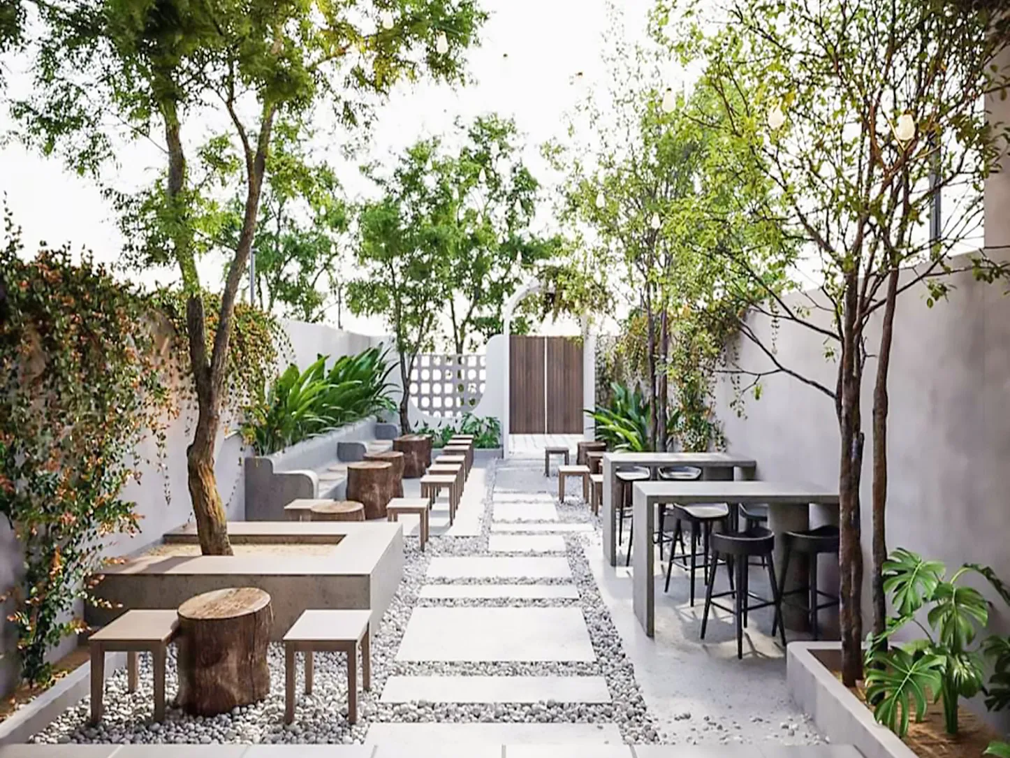 Outdoor seating area surrounded by lush greenery, wooden furniture, and soft lighting for a relaxing vibe.