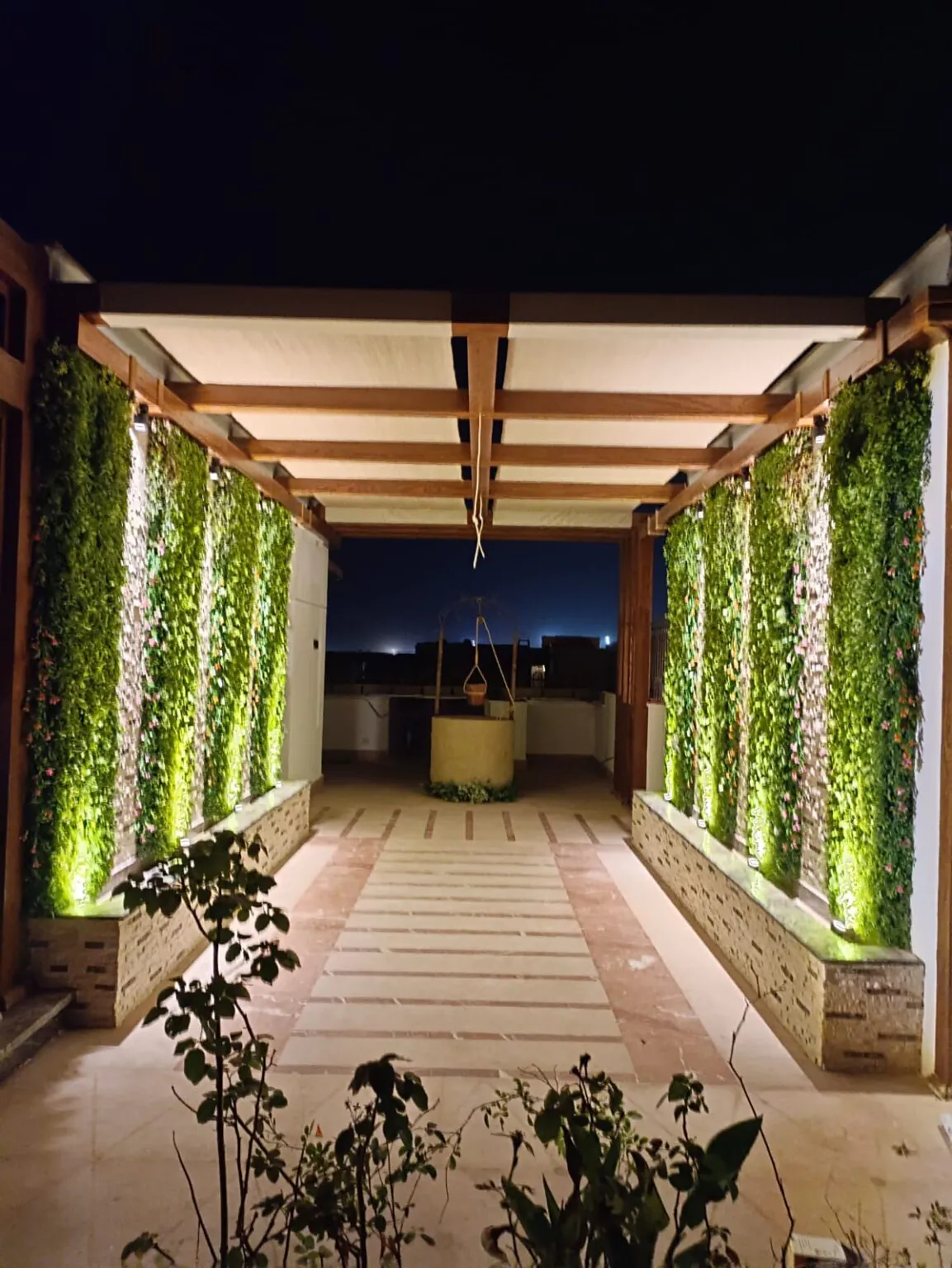 Stylish pergola with vertical green walls, sleek lighting, and a contemporary open design from Consept Art's site work portfolio.