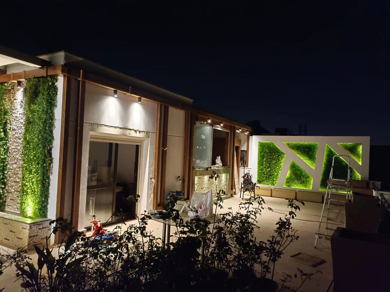 Elegant outdoor seating area with soft lighting, modern furniture, and green accents from Consept Art's site work portfolio.