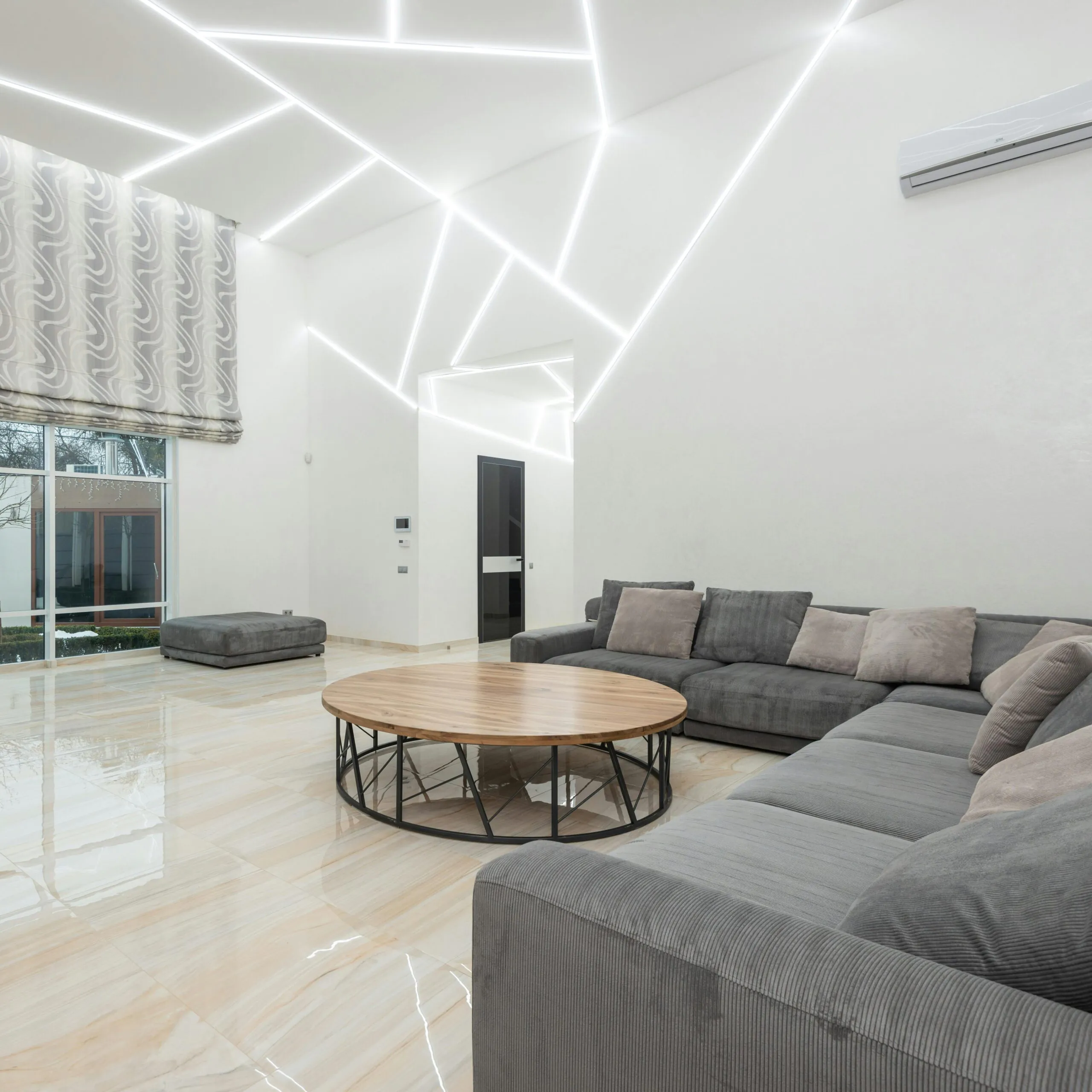 Modern living room with unique lighting, custom sofa, and abstract wall art in Egypt.